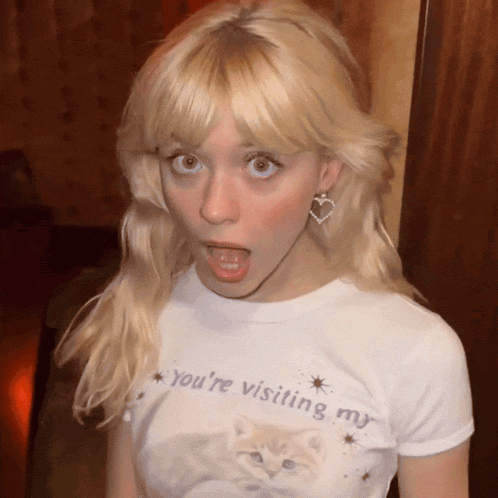 a girl wearing a white shirt that says you 're visiting my