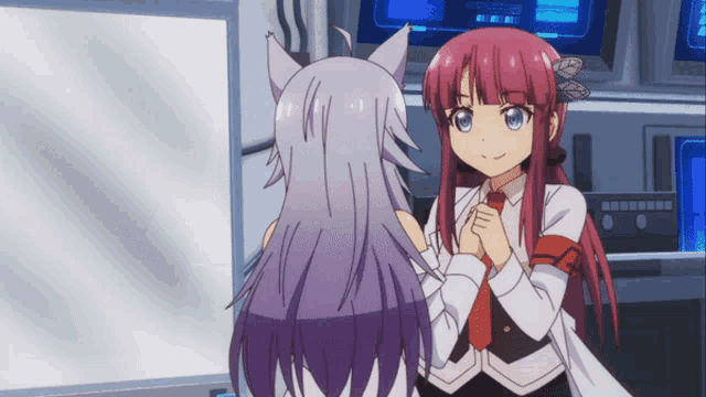 two anime girls are standing next to each other in front of a computer monitor