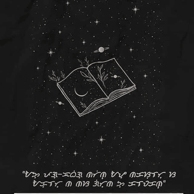 a black background with a drawing of an open book with a crescent moon and planets on it .