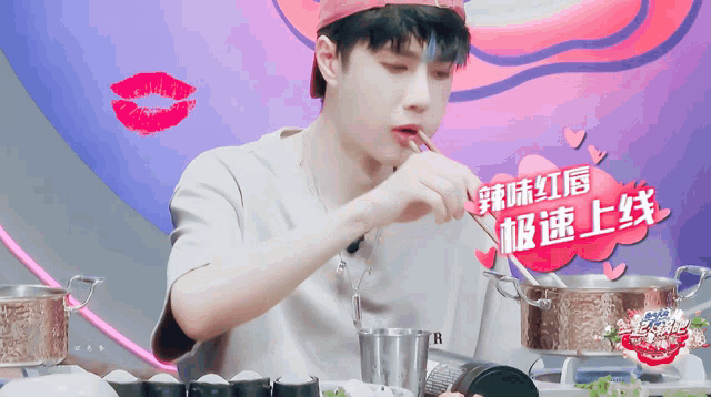 a man in a red hat is eating something with a spoon in his mouth