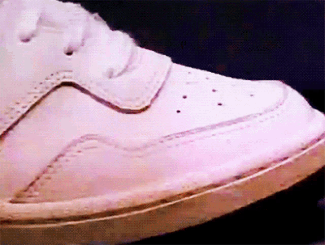 a close up of a pair of white sneakers