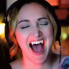 a woman wearing headphones is smiling with her eyes closed