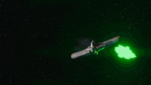 a computer generated image of a space ship with a green light coming out of it