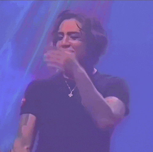 a man with a tattoo on his arm is covering his face