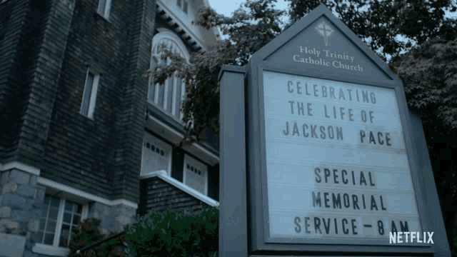 a sign for the holy trinity catholic church announces a special memorial service