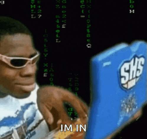 a man wearing sunglasses is looking at a shs device