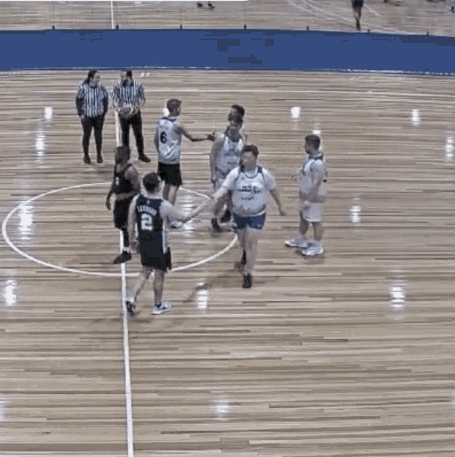 a group of basketball players on a court with one wearing a jersey with the number 23