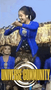 a woman in a blue dress is singing into a microphone in front of a crowd of people .
