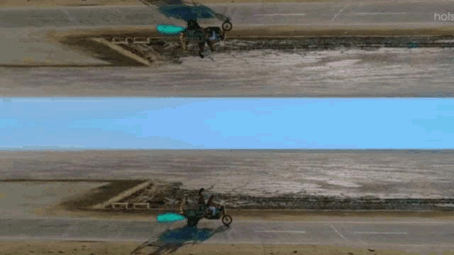a reflection of a person riding a motorcycle on a beach with the words hots on the bottom right