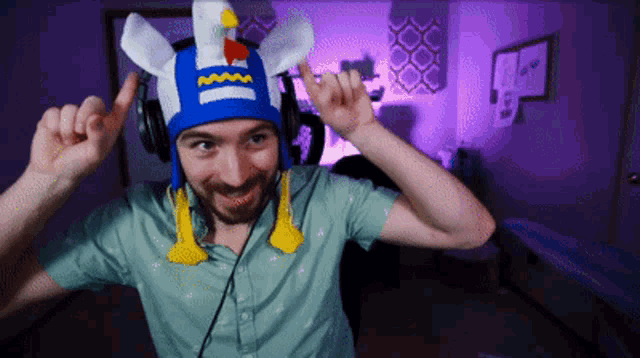 a man wearing headphones and a chicken hat