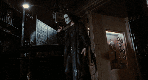 a person in a black jacket is holding a knife in their hand