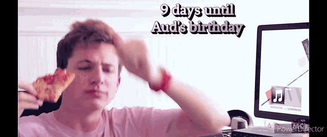 a man eating a slice of pizza in front of a computer screen with the words 9 days until audi 's birthday