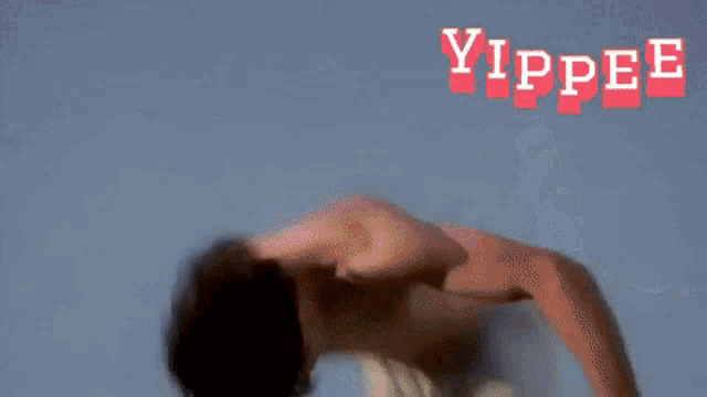 a man without a shirt is doing a flip in the air with the word yippee in red letters behind him