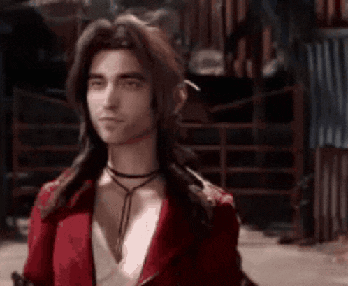 a man with long hair is wearing a red jacket and a choker necklace .