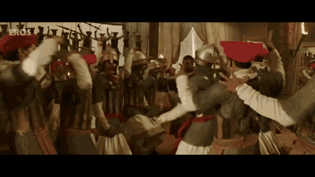 a group of soldiers are dancing together in a room .