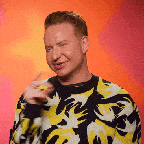 a man wearing a yellow and black sweater with the letter r on the front