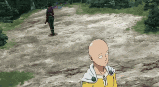 a bald man in a yellow jacket is standing on a dirt road next to a man in a purple shirt .
