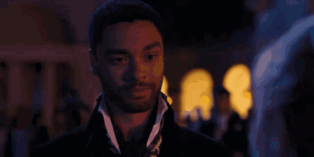 a close up of a man 's face with his eyes closed in a dark room .