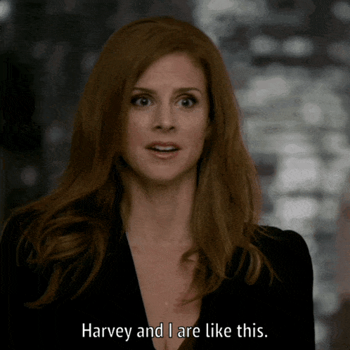 a woman in a black suit says " harvey and i are like this "