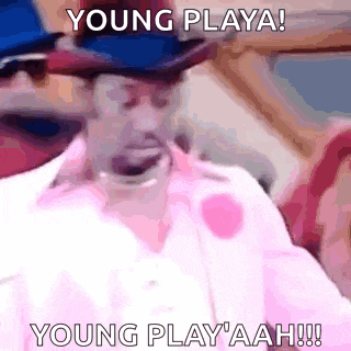 a man wearing a hat and a pink shirt is screaming .