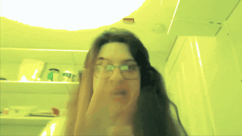 a blurry picture of a woman with glasses and headphones