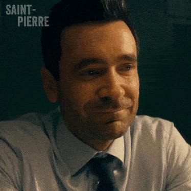 a man in a white shirt and tie with saint-pierre written on the bottom right