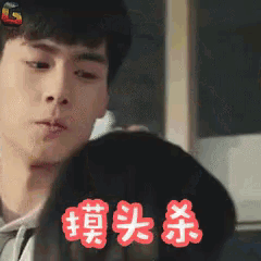 a man is looking at himself in a mirror with chinese characters on it
