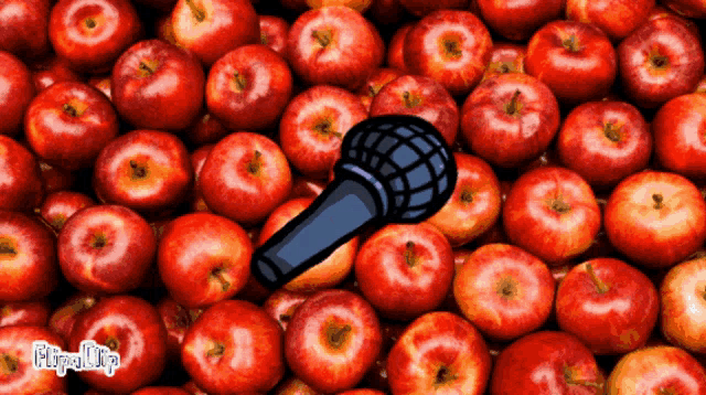 a bunch of apples with a microphone in the middle of them