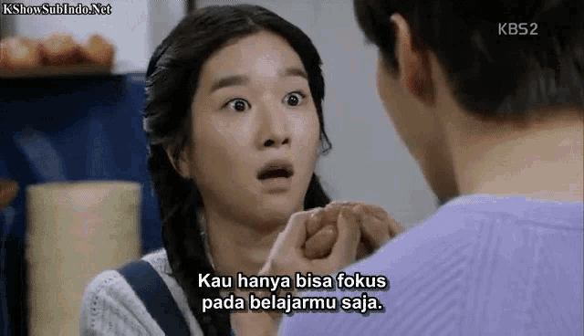 a woman with a surprised look on her face is talking to a man