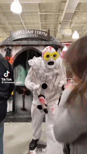a man in a clown costume is standing in front of a sign that says " twojay theatre "