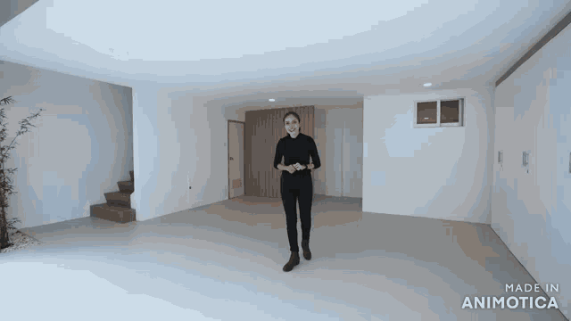a woman is standing in an empty room with the words made in animotica on the bottom