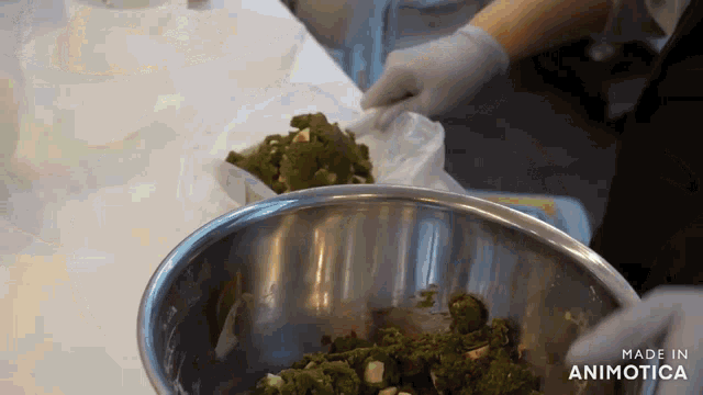 a person is mixing something in a metal bowl with the words made in animotica visible