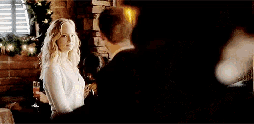 a man and a woman are standing next to each other in a room .
