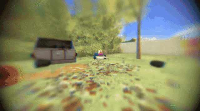 a blurred image of a person sitting on a chair in a field