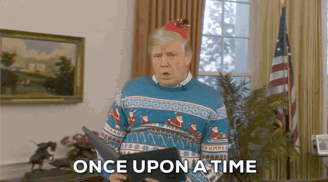 a man in a blue sweater is holding a book and the words once upon a time are above him