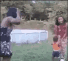 a man is taking a picture of a group of people in a park .