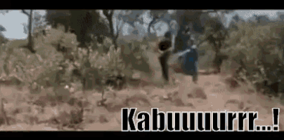 a group of people are walking through a forest with the words kabuuuurr written on the bottom of the screen .