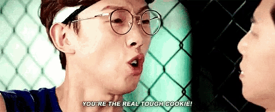 a man wearing glasses is talking to another man and says `` you 're the real tough cookie '' .
