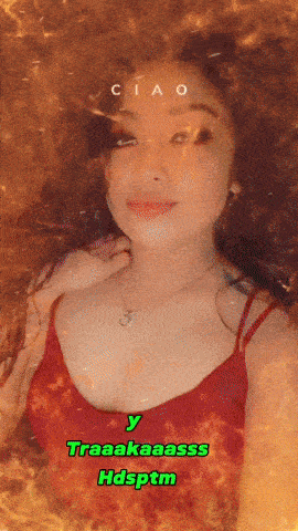 a woman in a red tank top is surrounded by flames and has ciao written on her face