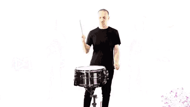 a group of people playing instruments including a man holding a snare drum