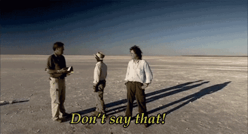 three men are standing in the middle of a desert and one of them is saying do n't say that !