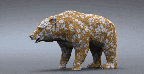 a statue of a brown and white bear with spots on it