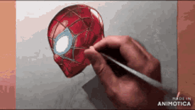a person is drawing a spider-man head with a brush