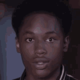 a close up of a young man 's face with a smile on his face .