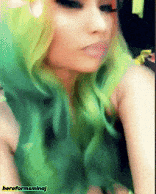 a woman with green hair is taking a selfie with the words hereformsmamaj on the bottom right