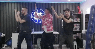 a group of men are dancing together in a room .