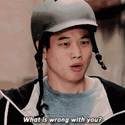a man wearing a helmet is asking what is wrong with you .