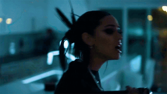 a close up of a woman 's face with a ponytail