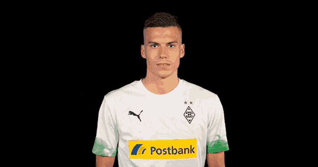 a soccer player wearing a white shirt with a postbank logo on it