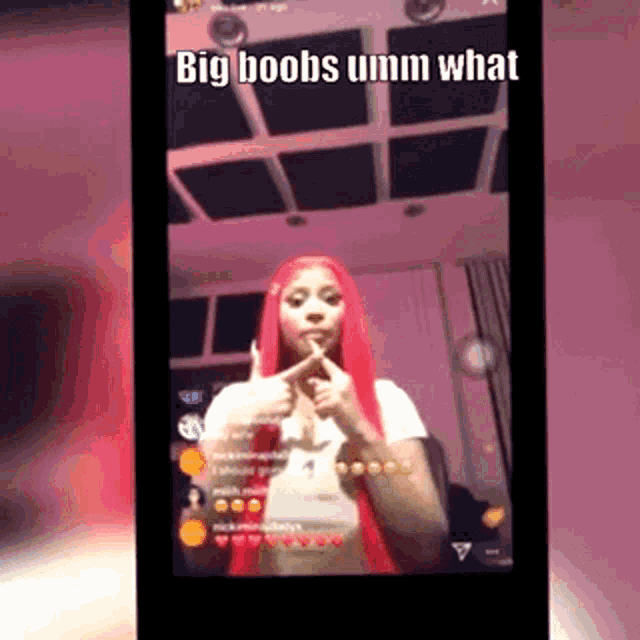 a woman with red hair is giving a thumbs up and says big boobs umm what